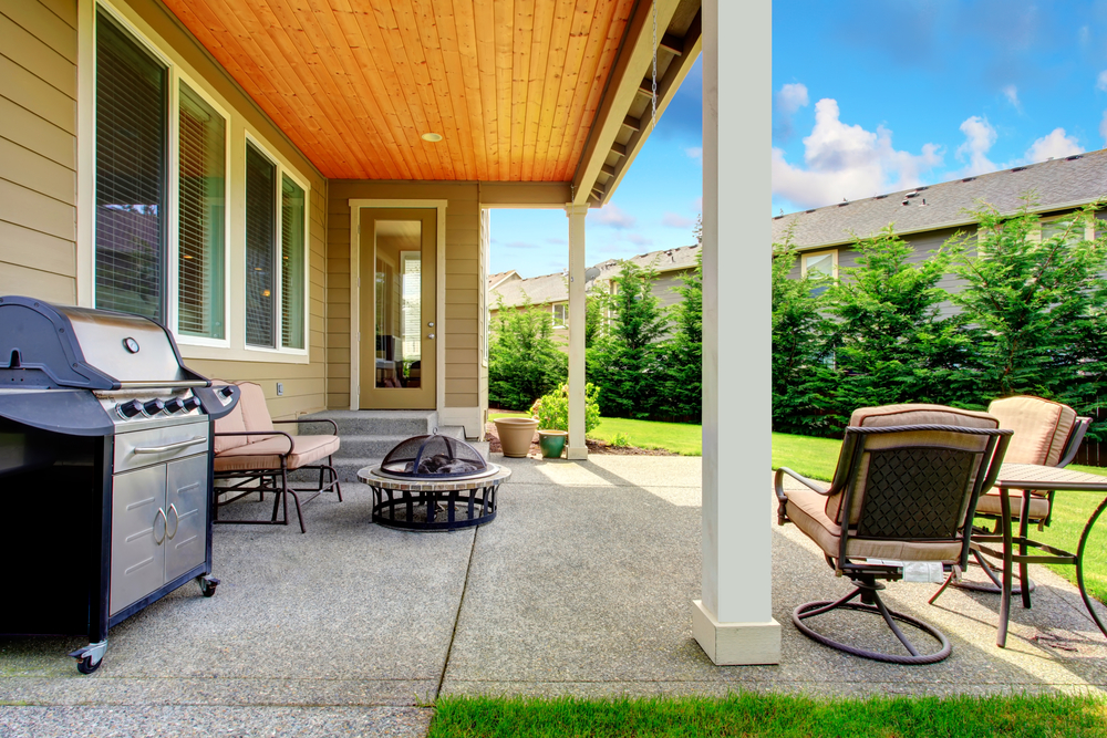 Backyard patio with BBQ and fire pit.