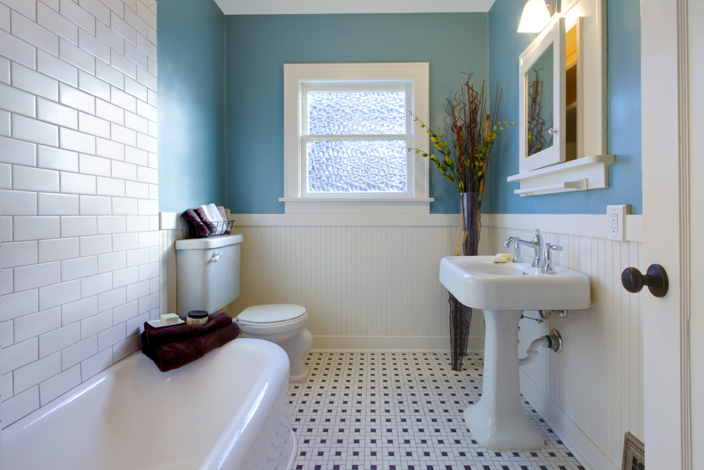 A redesigned bathroom featuring a new coat of paint, tiles and fixtures.